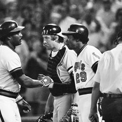 FILE - In this Oct. 5, 1979, file photo, California Angels' Don Baylor, left, gets a handshake from teammate Rod Carew (29) after hitting a home run in the fourth inning of Game 3 of the American League playoffs against the Baltimore Orioles, in Anaheim, Calif. Baltimore catcher Dave Skaggs is at center. Don Baylor, the 1979 AL MVP with the California Angels who went on to become manager of the year with the Colorado Rockies in 1995, has died. He was 68. Baylor died Monday, Aug. 7, 2017, at a hospital in Austin, Texas, his son, Don Baylor Jr., told the Austin American-Statesman. 