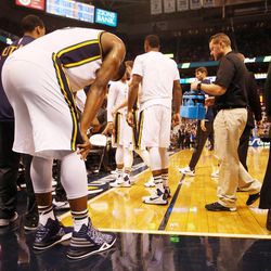Utah Jazz forward Derrick Favors slumps over after getting injured in the second half of an NBA regular season game against the Golden State Warriors at the Vivint Arena in Salt Lake City, Wednesday, March 30, 2016.