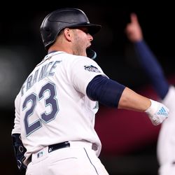Ty France #23 of the Seattle Mariners celebrates his three run home run against the Cleveland Guardians during the eighth inning during Opening Day at T-Mobile Park on March 30, 2023 in Seattle, Washington.