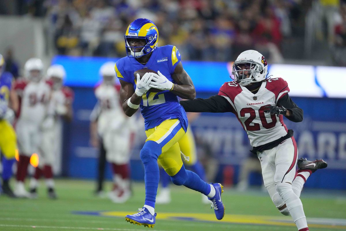 Los Angeles Rams wide receiver Van Jefferson (12) catches a pass as Arizona Cardinals cornerback Marco Wilson (20) defends during the second half of an NFC Wild Card playoff football game at SoFi Stadium.