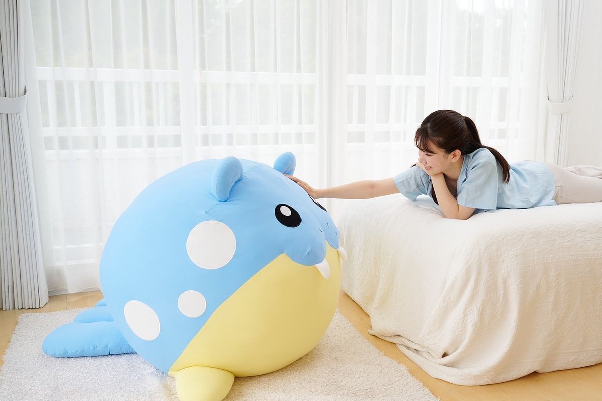 A photo of a person petting a life-size Spheal Pokémon plushie. It’s so big! Like so big. Apparently it weighs 16 pounds! 