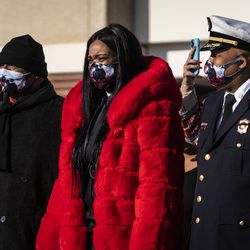 Felicia Townsend Plummer (center) and Jermaine Plummer (left), parents of Chicago Fire Department firefighter MaShawn Plummer, watch as their son’s casket is lifted on a fire truck after his funeral at the House of Hope church on the Far South Side, Thursday, Jan. 6, 2022. MaShawn Plummer, 30, of Engine 94 on the Northwest Side, died Dec. 21, five days after he was critically injured while fighting an apartment fire.