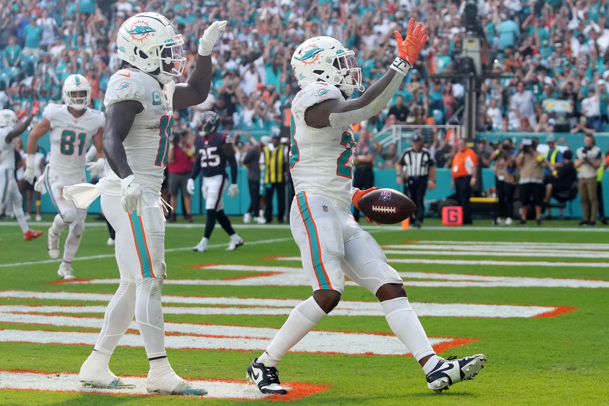 Jeff Wilson Jr. of the Miami Dolphins celebrates a touchdown with Tyreek Hill during the second quarter in the game against the Houston Texans at Hard Rock Stadium on November 27, 2022 in Miami Gardens, Florida.