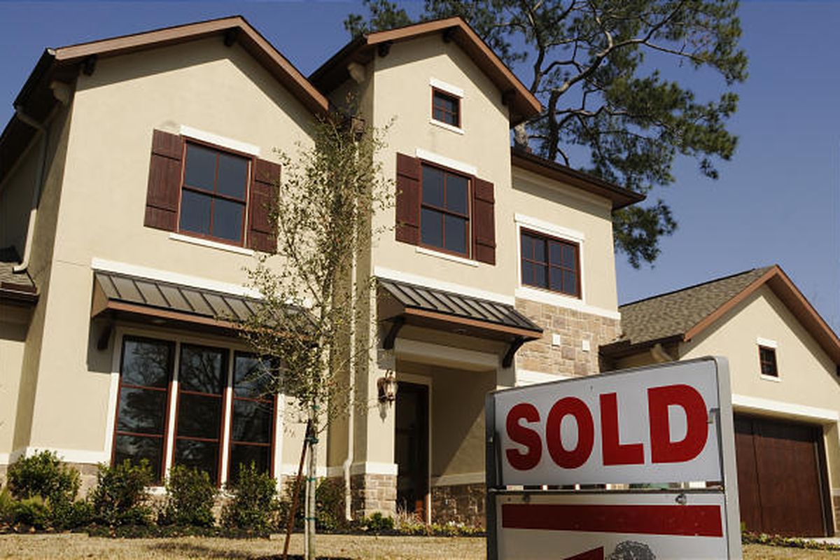 A sold sign sits outside a new home in Houston. Sales of new homes plunged to a record low in January, underscoring the formidable challenges facing the housing industry as it tries to recover from the worst slump in decades.
