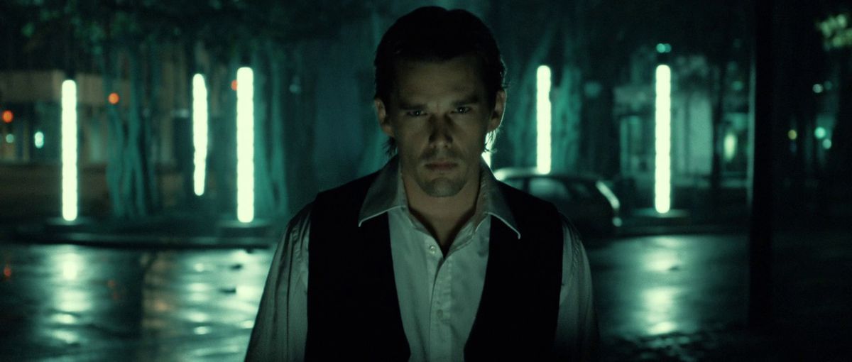 Ethan Hawke is pensive against a city at night in Daybreakers.