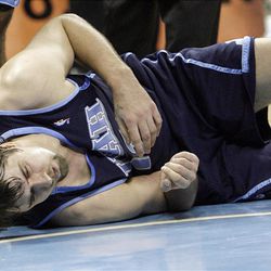 Utah Jazz center Mehmet Okur goes down with an ankle injury against the Nuggets during the NBA playoffs first round game 1 in Denver, Colorado, Sunday, April 18, 2010.  Jeffrey D. Allred, Deseret News