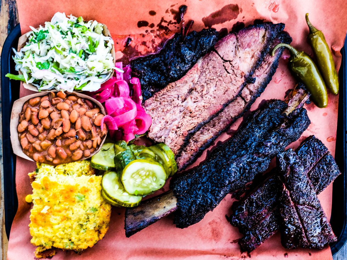 A platter of brisket, beans, and ribs. 