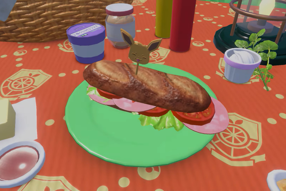 a ham sandwich on a table, surrounded by ingredients, with an eevee pick holding it together
