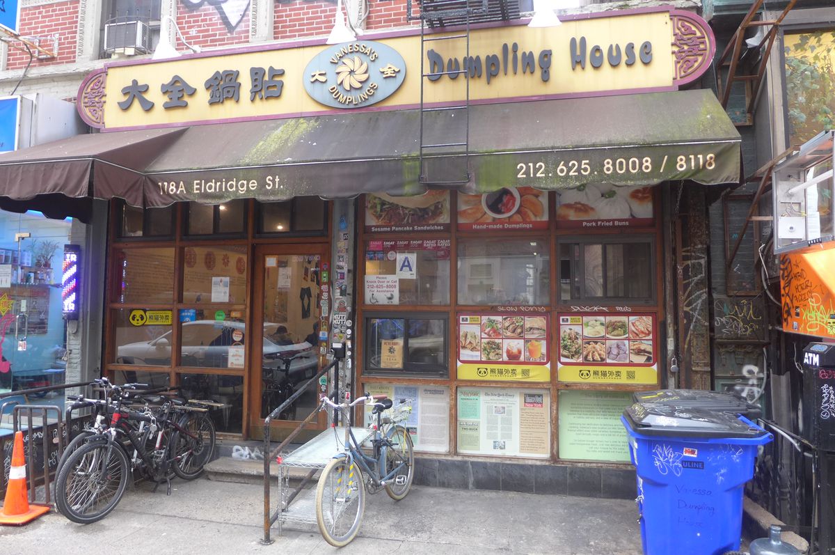 A faded wide storefront with two delivery bicycles parked in front.