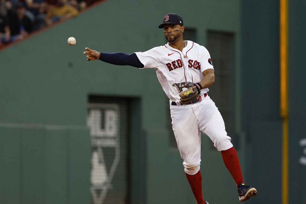 Xander Bogaerts #2 of the Boston Red Sox throws out a runner during the fifth inning against the Houston Astros at Fenway Park on May 18, 2022 in Boston, Massachusetts.