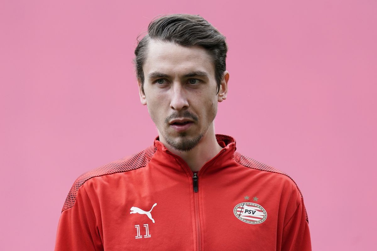 Adrian Fein in his PSV jacket during warm-ups against a soft pink background in May of 2021.