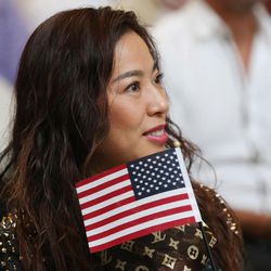 Liping Gao listens during a naturalization ceremony at the Capitol in Salt Lake City on Wednesday, Nov. 30, 2016. One hundred twenty-two citizenship applicants from 43 countries took the oath of allegiance, which was administered by Kristi Barrows, director of the U.S. Citizenship and Immigration Services' Denver district.