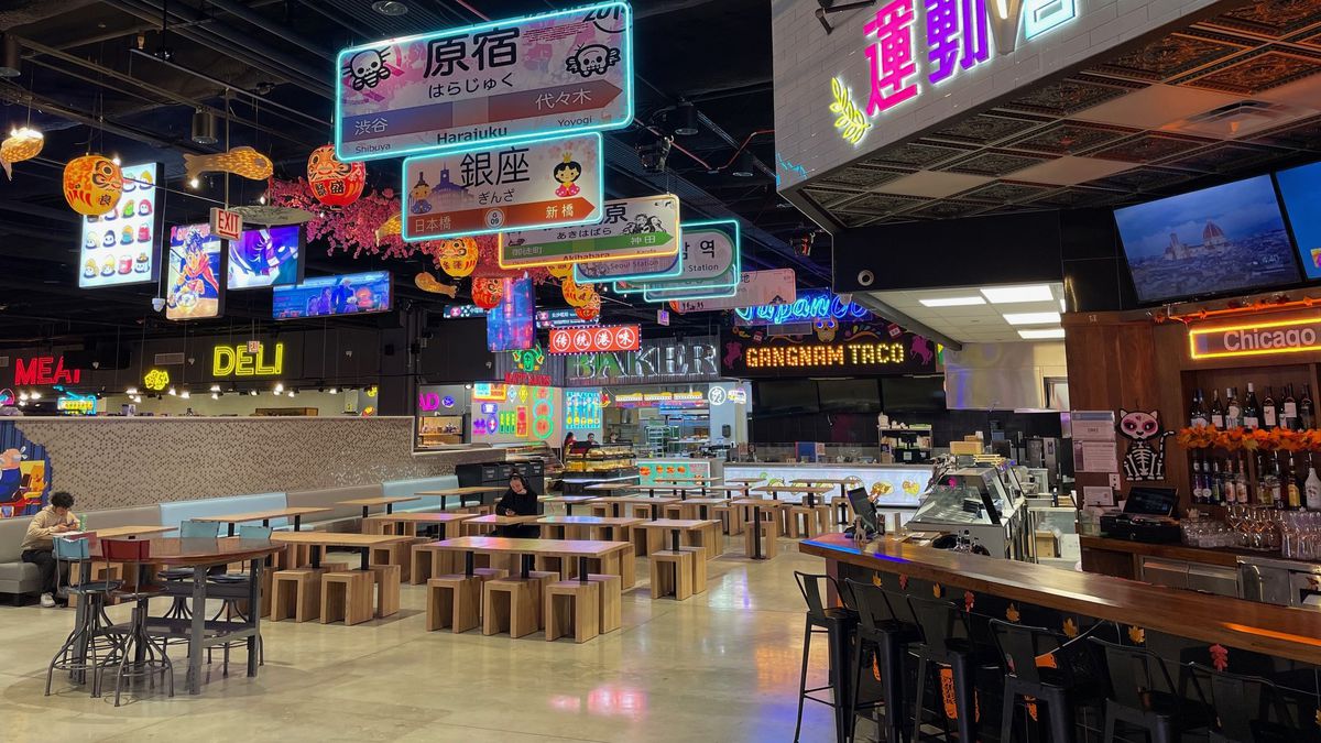 A food court with neon signage.
