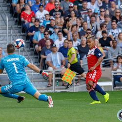 July 13, 2019 - Saint Paul, Minnesota, United States - FC Dallas midfielder Michael Barrios (21) shoots the ball over Minnesota United goalkeeper Vito Mannone (1) during the match at Allianz Field.
