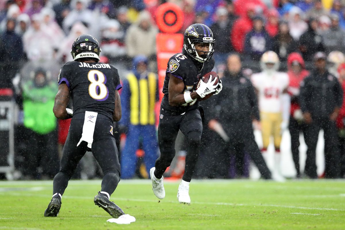 Marquise Brown of the Baltimore Ravens takes a pitch from Lamar Jackson against the San Francisco 49ers at M&amp;T Bank Stadium on December 01, 2019 in Baltimore, Maryland.