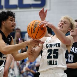West Jordan’s Esafe Taufahema grabs Copper Hills’ Luke Moir by the arm as they wrestle for the ball during a high school boys basketball game at Copper Hills in West Jordan on Friday, Jan. 14, 2022.