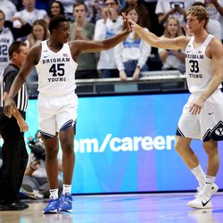 Brigham Young Cougars forward Fousseyni Traore (45) and Brigham Young Cougars forward Caleb Lohner (33) high-five during a timeout as BYU and Pacific play in an NCAA basketball game in Provo at the Marriott Center on Thursday, Jan. 6, 2022.
