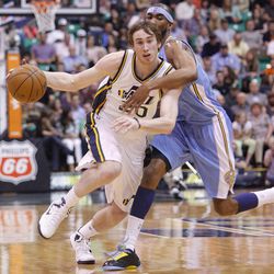 Utah's Gordon Hayward is fouled by Denver's Cory Brewer as the Utah Jazz and the Denver Nuggets play Wednesday, April 3, 2013 in Salt Lake City at EnergySolutions Arena. Denver beat the Jazz 113-96.