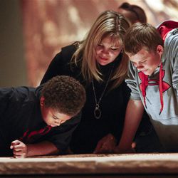 Camille Pankow ,center, looks at a display with her son Juandel ,left, and friend Josh Schmidt at the new Utah Natural History Museum Thursday, Nov. 10, 2011.