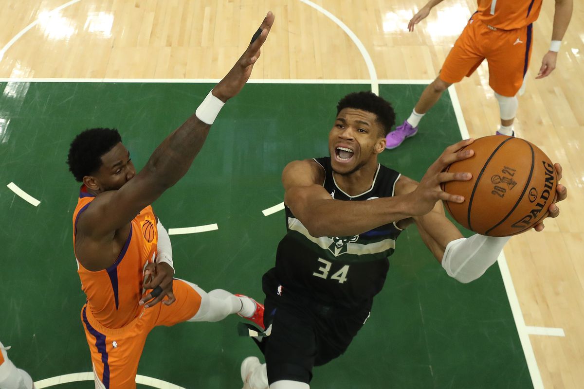 Giannis Antetokounmpo #34 of the Milwaukee Bucks goes up for a shot against Deandre Ayton #22 of the Phoenix Suns during the second half in Game Six of the NBA Finals at Fiserv Forum on July 20, 2021 in Milwaukee, Wisconsin.