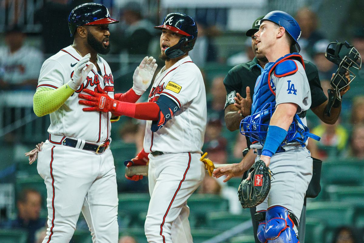 Orlando Arcia of the Atlanta Braves calms down Marcell Ozuna during and argument with Will Smith #16 of the Los Angeles Dodgers during the fourth inning the game between the Atlanta Braves and the Los Angeles Dodgers at Truist Park on May 22, 2023 in Atlanta, Georgia.