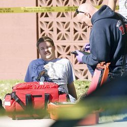 West Valley police detective Shaun Cowley sits on the ground as he is checked out by paramedics following the shooting death of Danielle Willard on Nov. 2, 2012. 
Nearly 100 criminal cases investigated by the department have now been dismissed because of credibility issues connected to allegations of corruption.