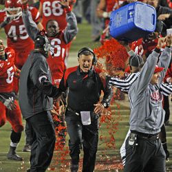 Coach Kyle Whittingham is doused as celebrations start toward the end of the game as the University of Utah defeats Brigham Young University 48-24 in Salt Lake City on Nov. 22, 2008.  