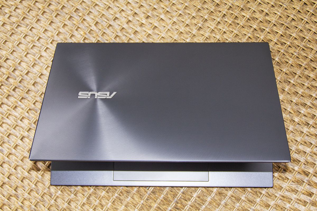 The Asus Zenbook 13 OLED half open, seen from above.