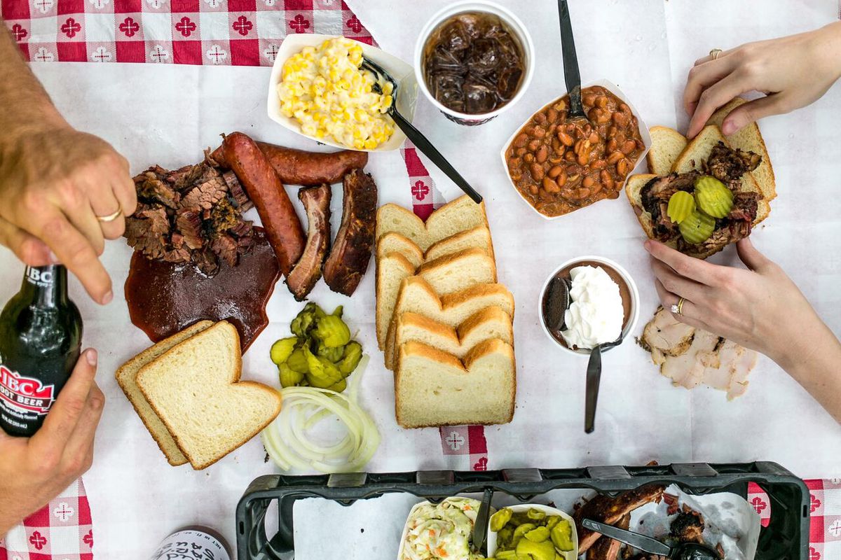 A table of meats, breads, and more.