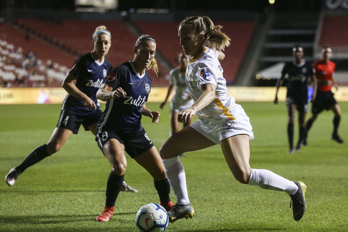 Utah Royals FC forward Amy Rodriguez (8) dribbles the ball looking to score against the Seattle Reign FC during their match at Rio Tinto Stadium in Sandy on Friday, June 28, 2019.