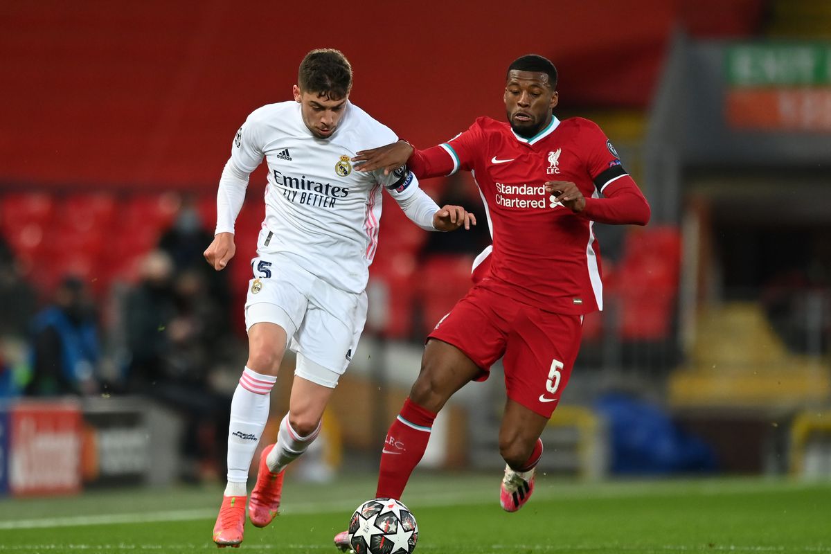 Federico Valverde of Real Madrid is challenged by Georginio Wijnaldum of Liverpool during the UEFA Champions League Quarter Final Second Leg match between Liverpool FC and Real Madrid