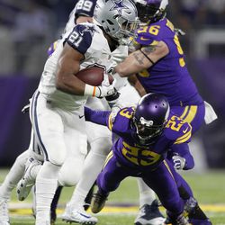 Dallas Cowboys running back Ezekiel Elliott (21) runs from Minnesota Vikings cornerback Terence Newman (23) during the second half of an NFL football game Thursday, Dec. 1, 2016, in Minneapolis. 