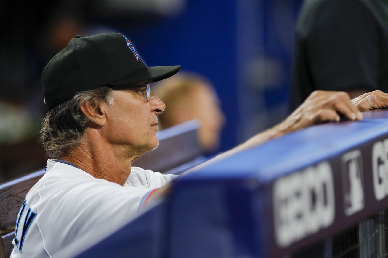 Miami Marlins manager Don Mattingly (8) watches from inside the dugout during the game against the New York Mets at loanDepot Park.