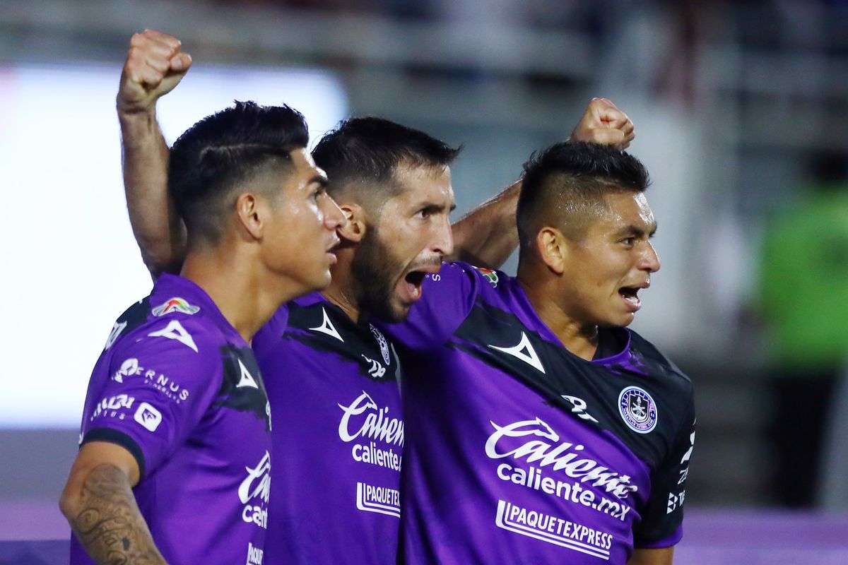 Gonzalo Sosa (C) celebrates with teammates Roberto Meraz and Miguel Sansores after scoring the first goal of his team during the 2nd round match between Mazatlan FC and America as part of the Torneo Grita Mexico C22 Liga MX at Kraken Stadium on February 16, 2022 in Mazatlan, Mexico.