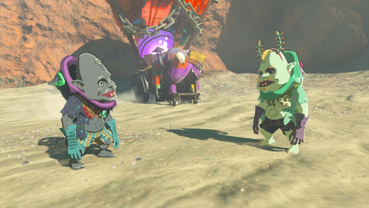 Kilton and Koltin standing on sandy ground in front of Koltin’s colorful stall in The Legend of Zelda: Tears of the Kingdom