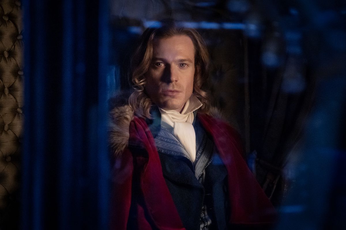 Sam Reid smolders as Lestat de Lioncourt through a window in Interview with the Vampire season 2