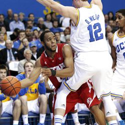 Utah guard Chris Hines, left, looks to pass as UCLA's David Wear (12) and Lazeric Jones defend in the first half of an NCAA college basketball game, Thursday, Jan. 26, 2012, in Los Angeles. (AP Photo/Jason Redmond)