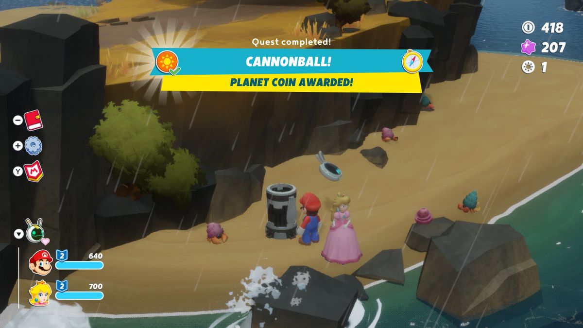 Mario and Peach stand next to a capsule while a “quest complete, Cannonball!” message flashes on the screen in Mario + Rabbids Sparks of Hope
