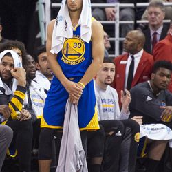 Golden State guard Stephen Curry (30) watches the first half of an NBA basketball game between Utah and Golden State in Salt Lake City on Thursday, Dec. 8, 2016.