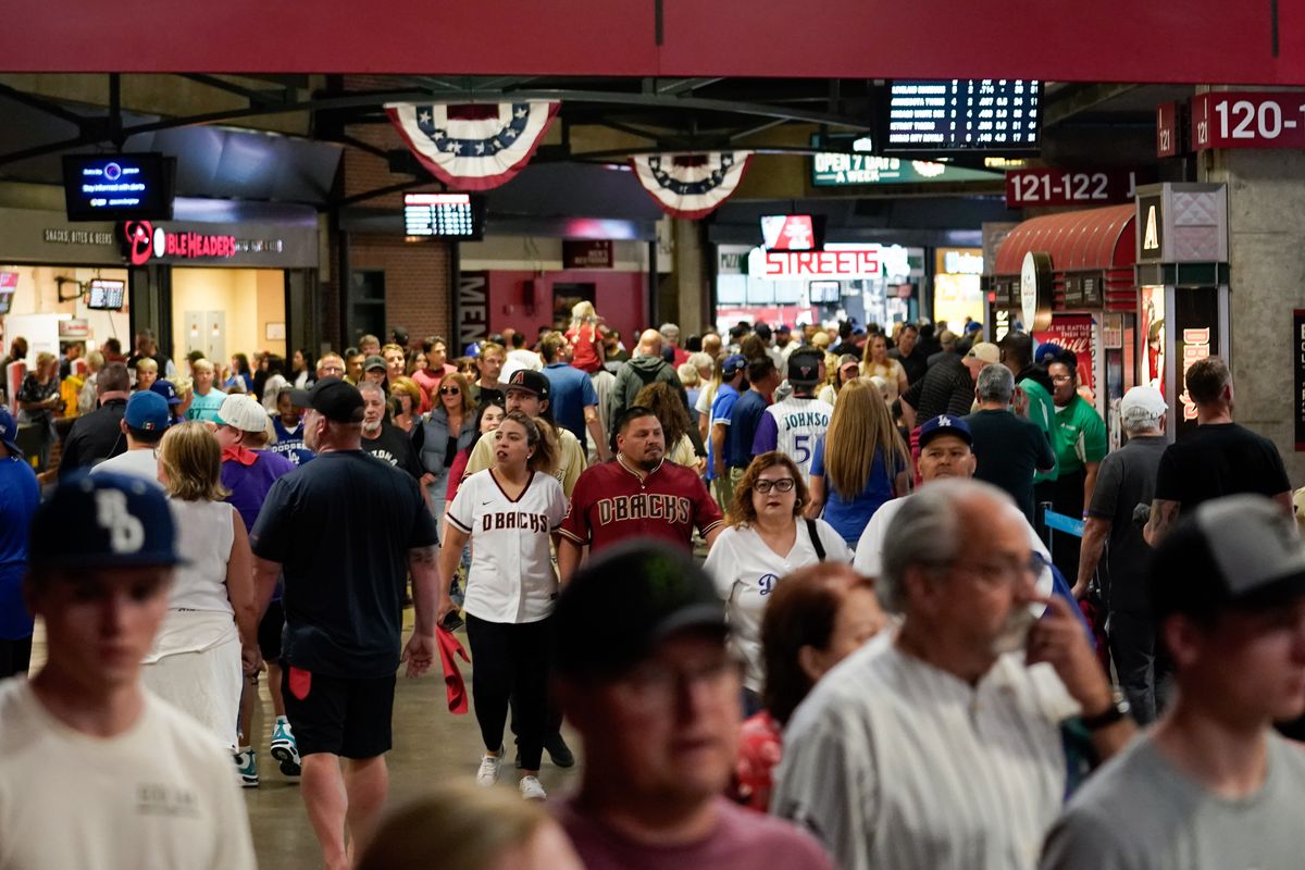 Fans walk along the concourse prior to the game between the Los Angeles Dodgers and the Arizona Diamondbacks at Chase Field on Thursday, April 6, 2023 in Phoenix, Arizona.
