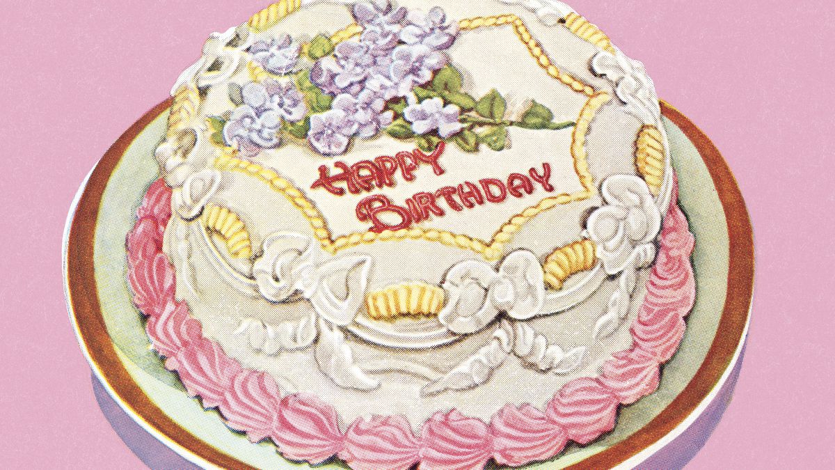 An illustration of a single-tiered birthday cake covered in white icing with pink and yellow detailing and purple flowers. “Happy Birthday” is written in red icing.