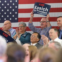 Crowd members cheer as Ohio Gov. John Kasich speaks at a Town Hall meeting in the Guest House at the University of Utah Friday, March 18, 2016.