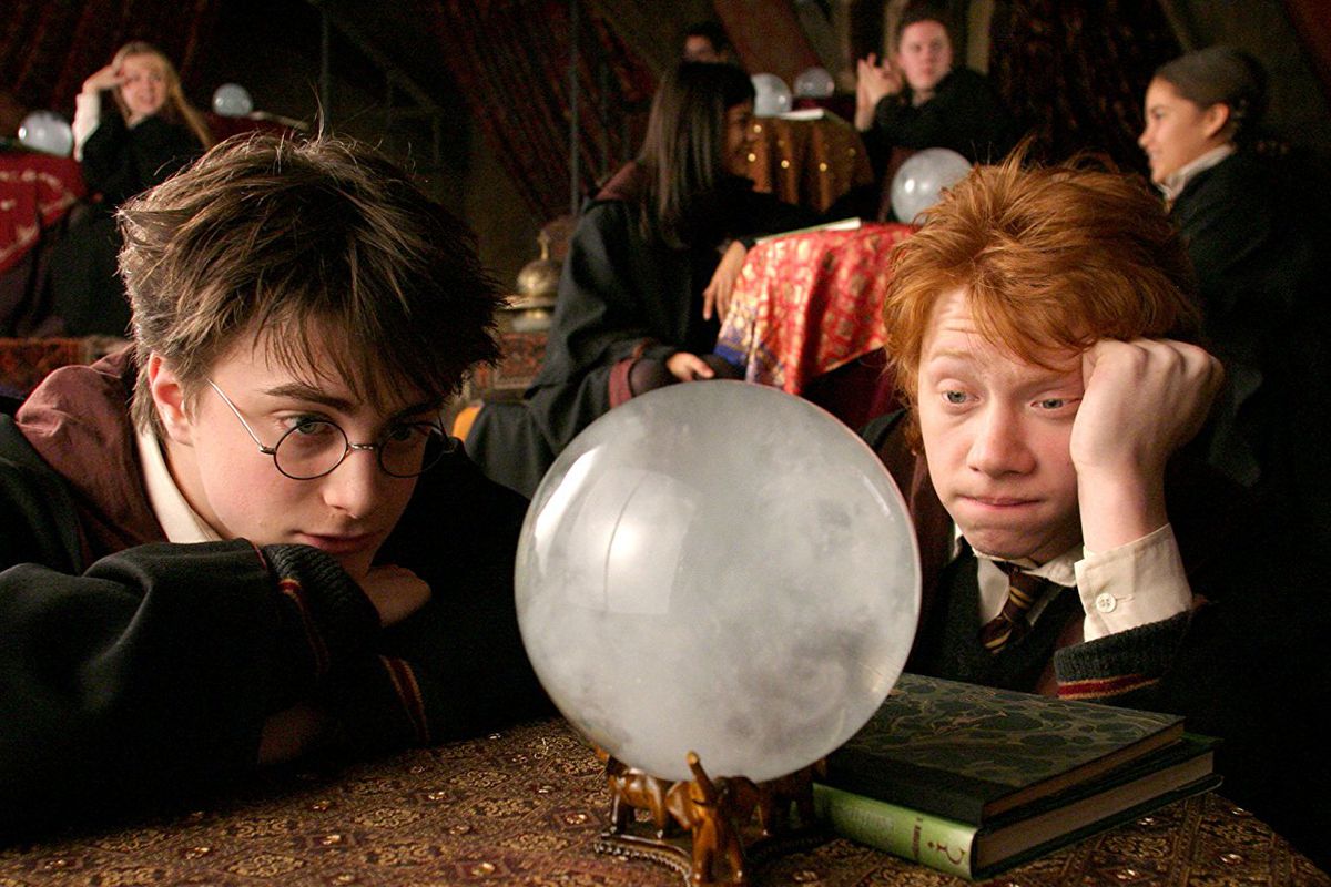 Harry and Ron gaze hopelessly into a crystal ball.