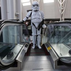 Aaron Mead, dressed as a stormtrooper from Star Wars, rides the escalator at Utah's first Comic Con at the Salt Palace Convention Center in Salt Lake City on Thursday, Sept. 5, 2013.