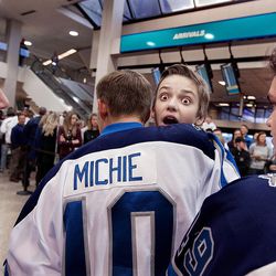 Karsen Wight reacts when he spots his girlfriend while he is welcomed home by his hockey teammates at Salt Lake City International Airport on Friday, Nov. 18, 2016. Wight and his family were involved in an automobile accident while driving to a hockey tournament in Denver. The parents died and Wight and his brother, Kyle, had been recuperating from their injuries in a Denver hospital since the accident occurred last week.