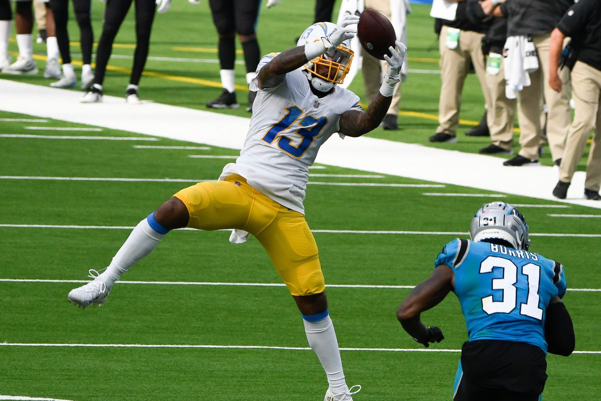 Los Angeles Chargers wide receiver Keenan Allen (13) makes a leaping catch in front of Carolina Panthers strong safety Juston Burris (31) during the third quarter at SoFi Stadium.