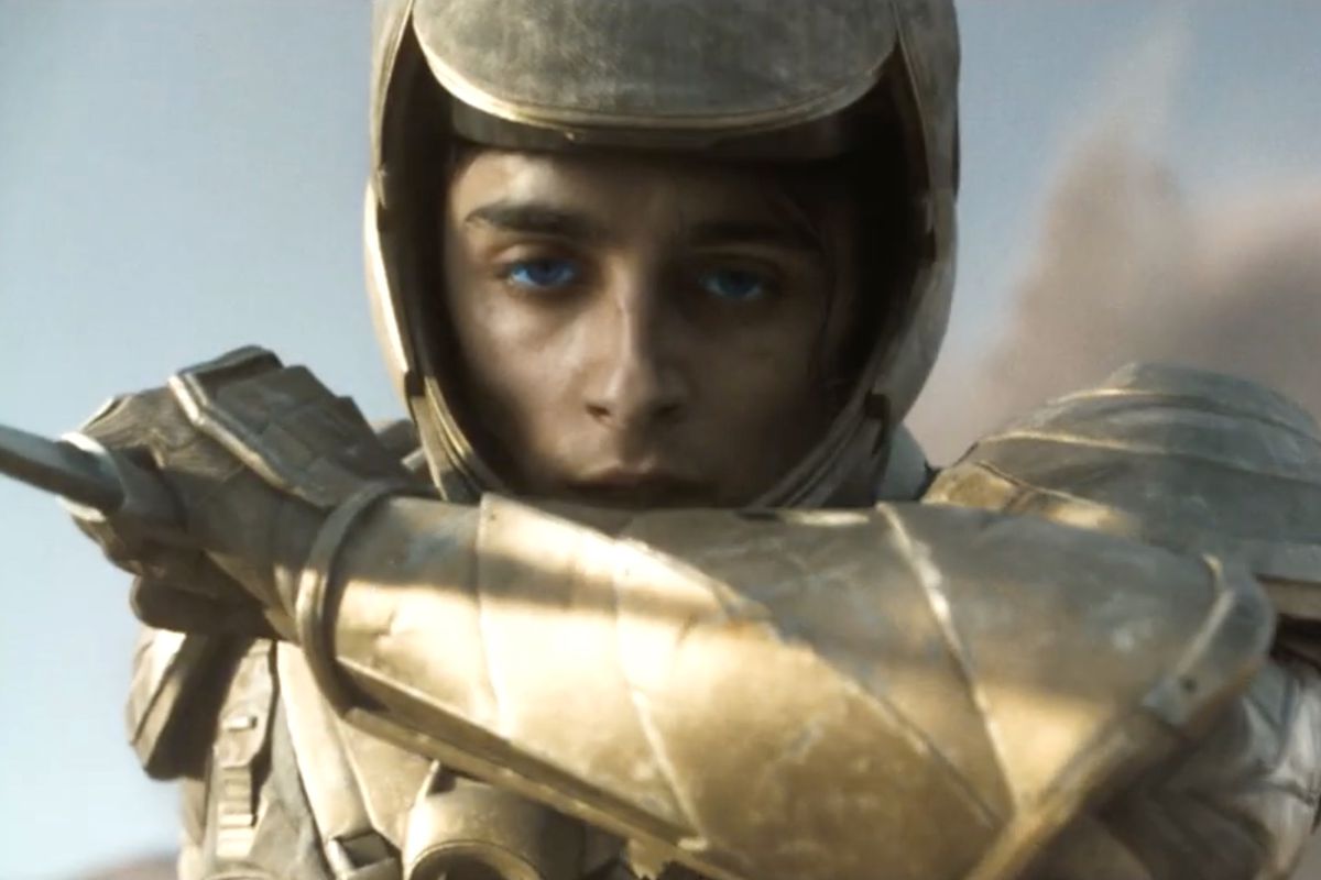 a close-up of Paul (Timothee Chalamet) wearing gold armor in Dune