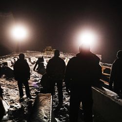 In this Thursday, Dec. 1, 2016 photo, military veterans walk onto a closed bridge to protest across from police protecting the Dakota Access oil pipeline site in Cannon Ball, N.D. More than 525 people from across the country have been arrested since August. In a recent clash between police and protesters near the path of the pipeline, officers used tear gas, rubber bullets and large water hoses in sub-freezing temperatures. 