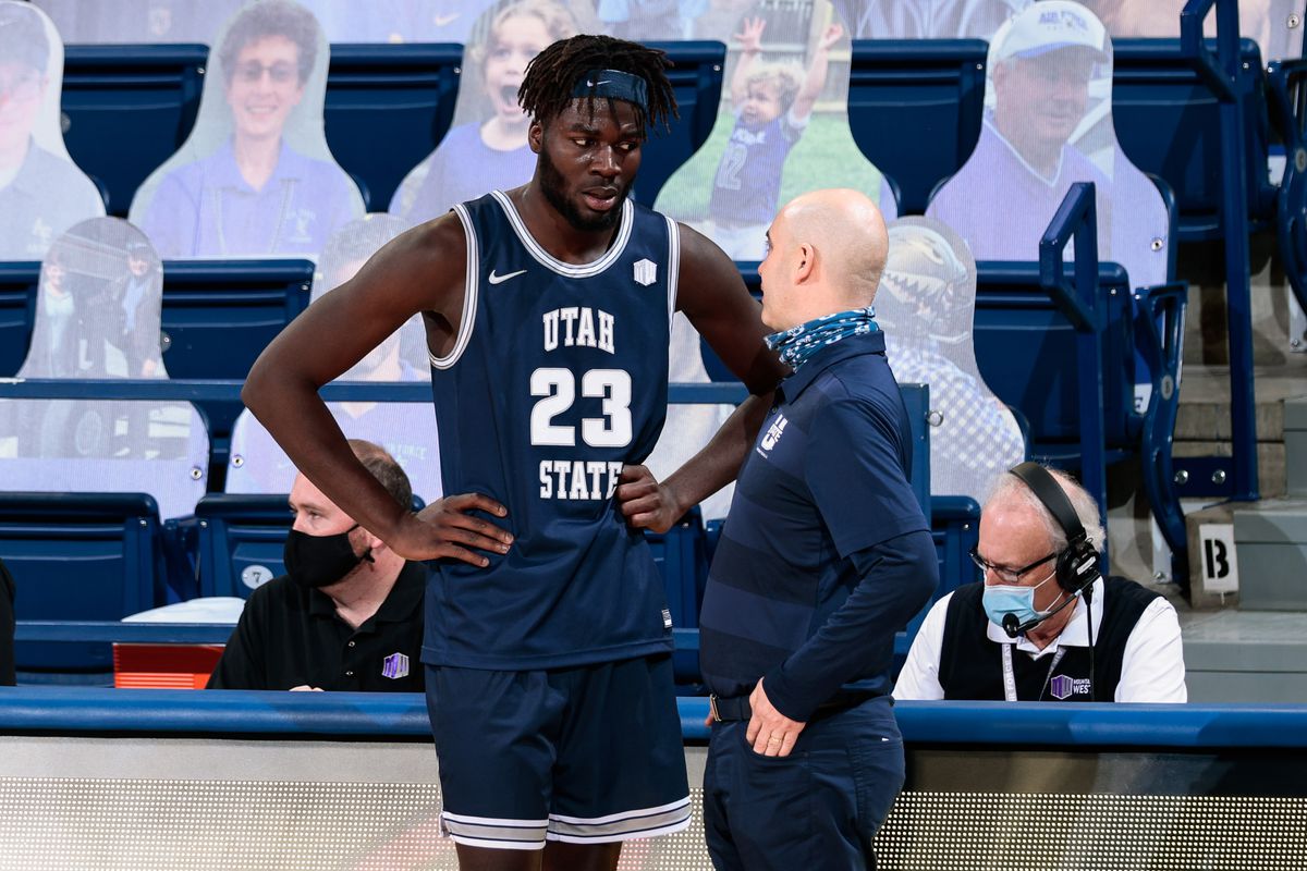 Utah State Aggies head coach Craig Smith talks with center Neemias Queta in the second half against the Air Force Falcons at Clune Arena.