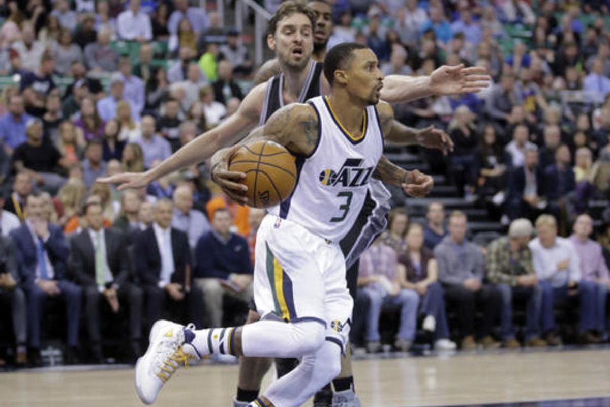 Utah Jazz guard George Hill (3) drives around San Antonio Spurs center Pau Gasol, rear, in the second half during an NBA basketball game Friday, Nov. 4, 2016, in Salt Lake City. The Spurs won 100-86.